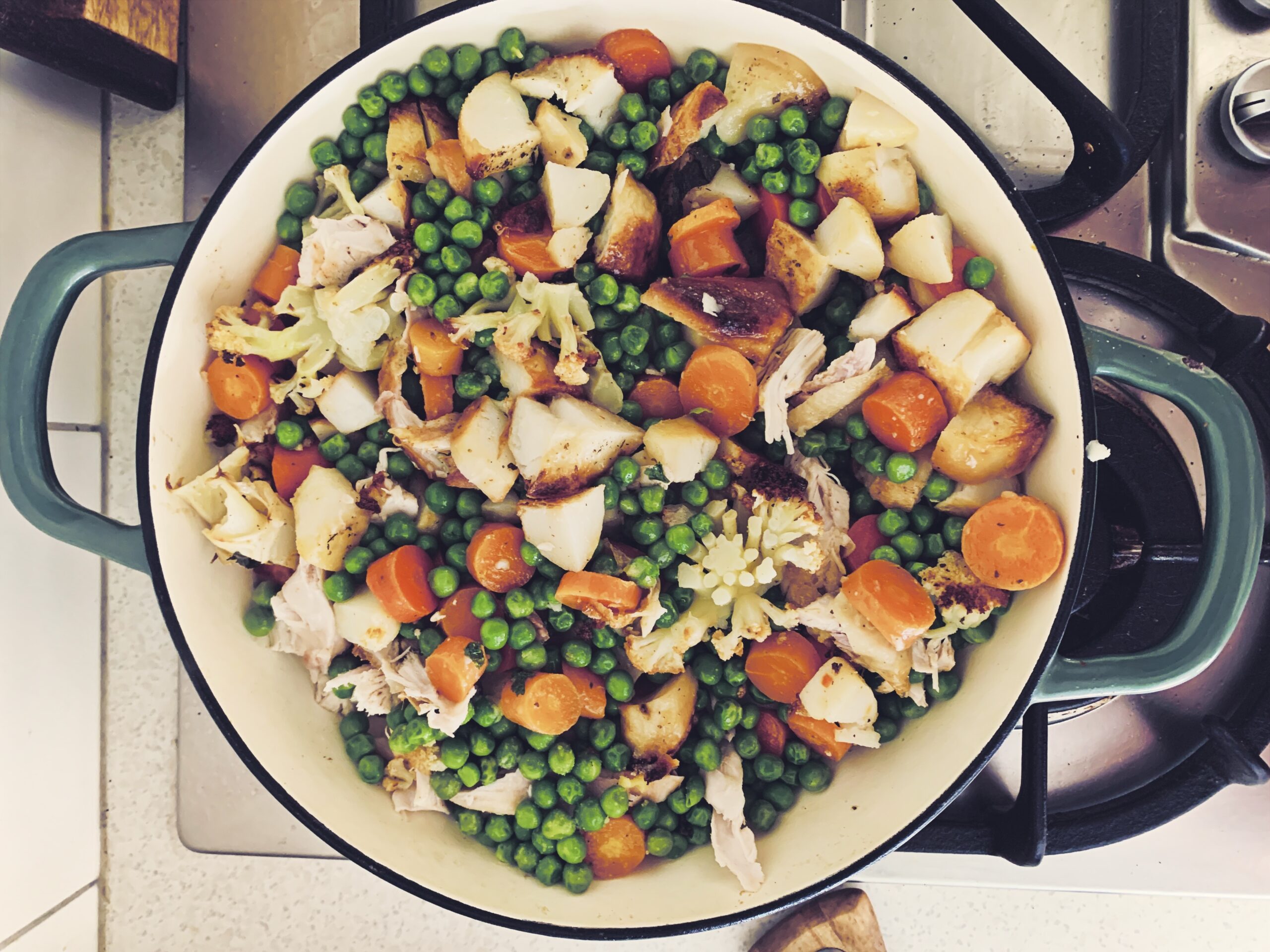 a pan with chicken and vegetable bubble and squeak frying in it