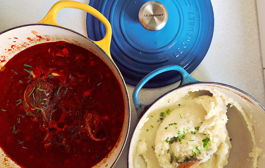 A pot of lamb shanks and a pot of mashed potato