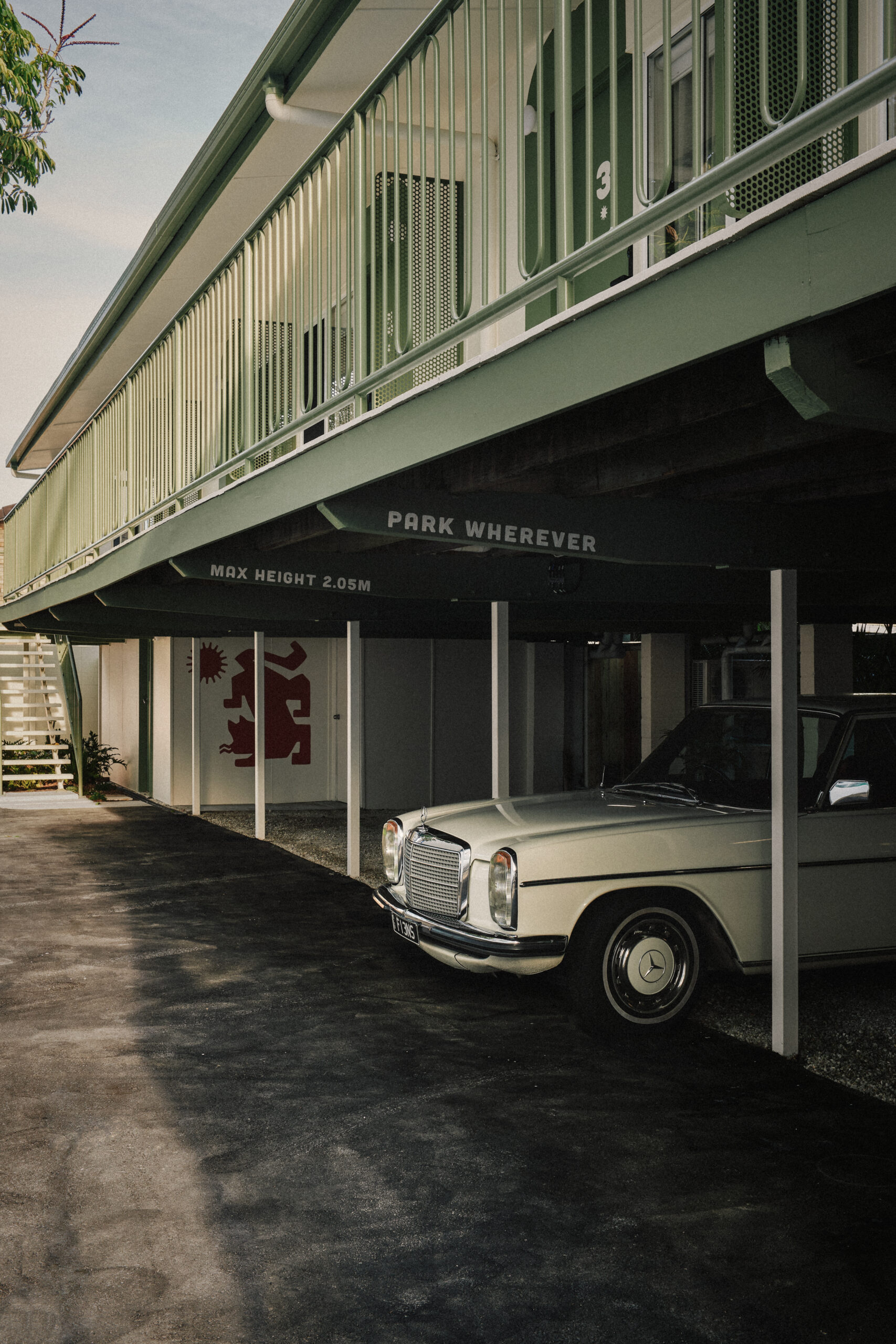 A vintage Mercedes parked in the under cover parking garage. The Cheshire Cat Motel, Gold Coast, Queensland, Australia