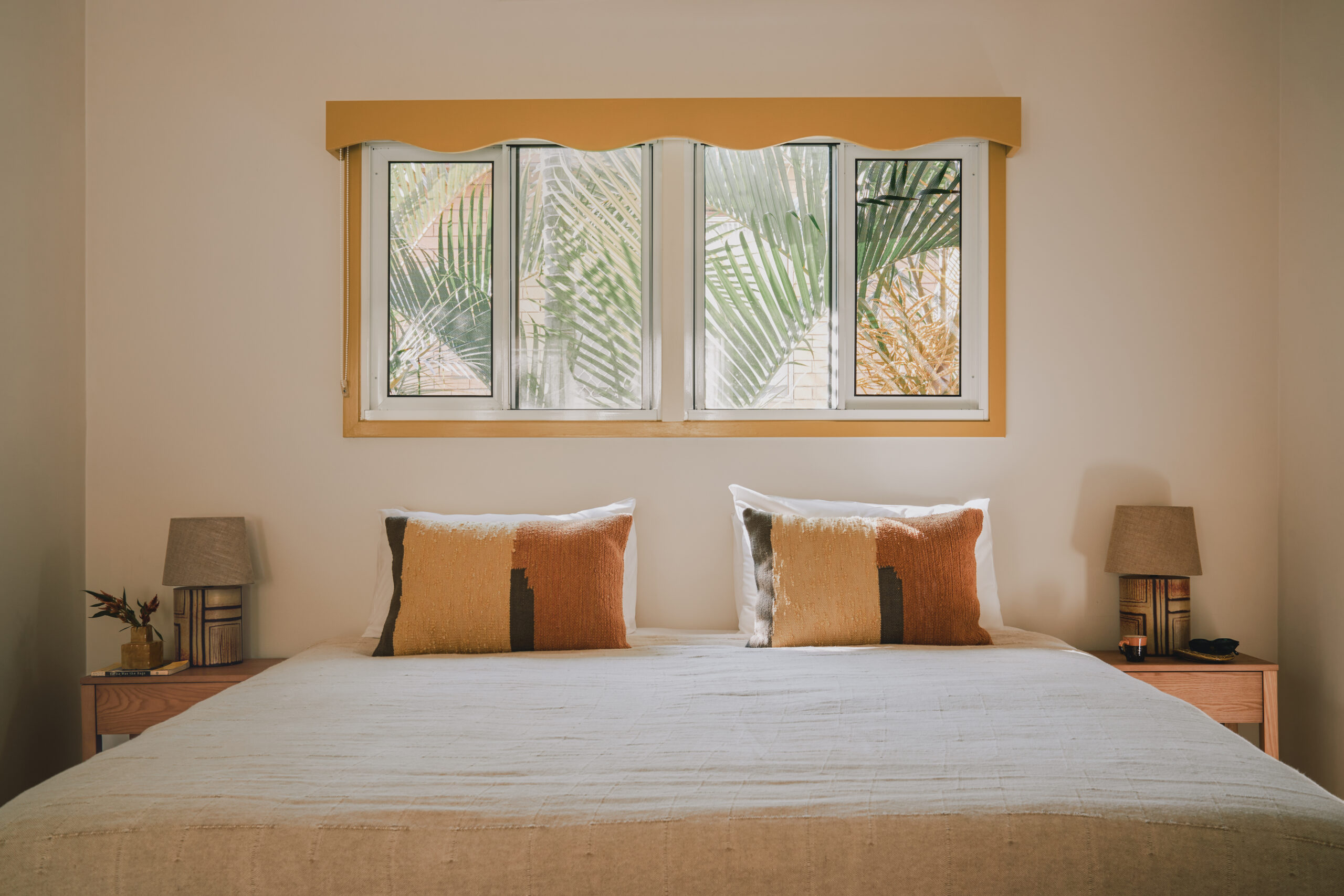 Bedroom photo with bed under window. It's very sunny and warm. The Cheshire Cat Motel, Gold Coast, Queensland, Australia